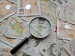 money and magnifying glass